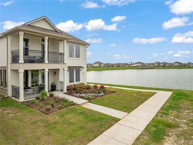 405 Short Bough Ln, Slidell, LA 70461 - view of front of house with a balcony, stucco siding, a water view, and a front yard