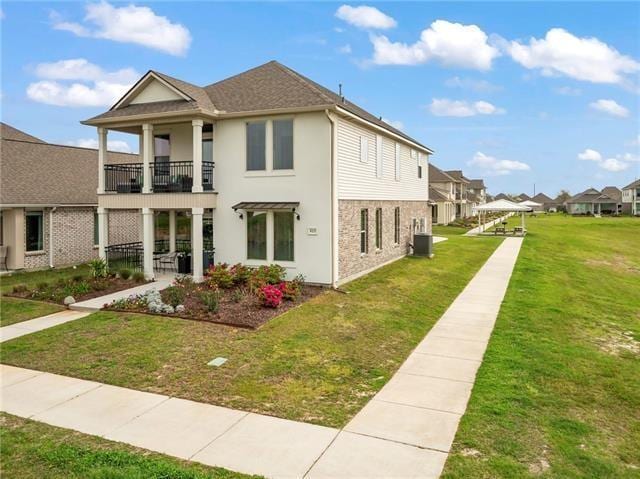 405 Short Bough Ln, Slidell, LA 70461 - view of property exterior featuring a balcony, a yard, a residential view, and stucco siding