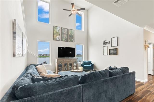 405 Short Bough Ln, Slidell, LA 70461 - living room with dark wood-style flooring, a ceiling fan, plenty of natural light, and a high ceiling
