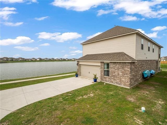 405 Short Bough Ln, Slidell, LA 70461 - view of home's exterior featuring brick siding, a yard, a water view, and concrete driveway