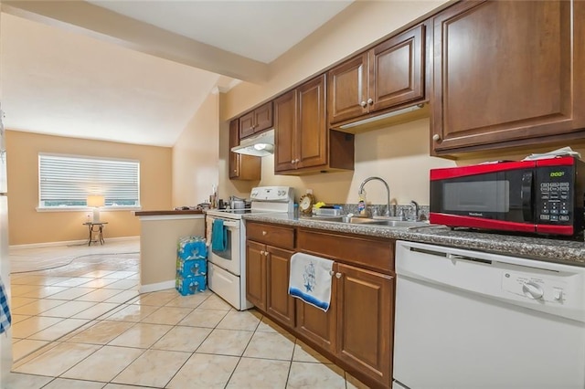 1020 Saint Julien Dr Unit 226, Kenner, LA 70065 - kitchen with white appliances, light tile patterned floors, under cabinet range hood, lofted ceiling, and brown cabinets