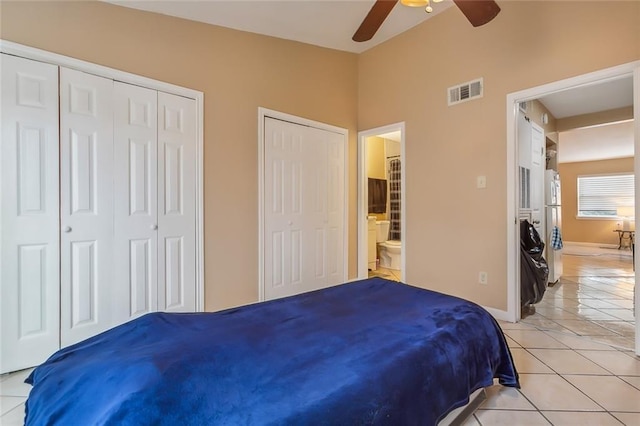 1020 Saint Julien Dr Unit 226, Kenner, LA 70065 - bedroom with light tile patterned floors, two closets, freestanding refrigerator, ceiling fan, and ensuite bath