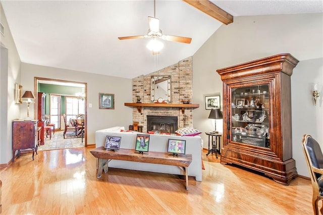 706 Natalie Dr, Houma, LA 70364 - living room featuring lofted ceiling with beams, a fireplace, wood finished floors, baseboards, and ceiling fan
