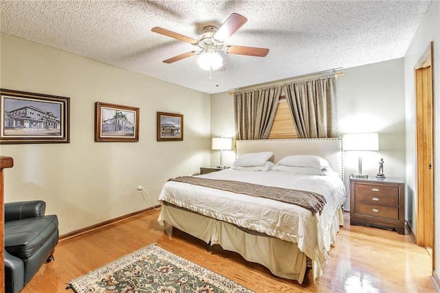 706 Natalie Dr, Houma, LA 70364 - bedroom featuring baseboards, light wood-style flooring, ceiling fan, and a textured ceiling