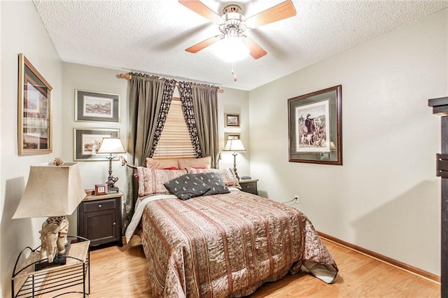 706 Natalie Dr, Houma, LA 70364 - bedroom featuring baseboards, light wood-type flooring, ceiling fan, and a textured ceiling
