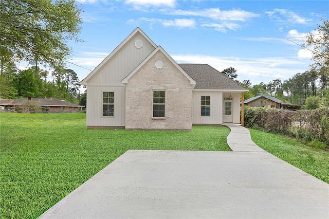 35378 Liberty Dr, Slidell, LA 70460 - back of house with a lawn, brick siding, and a patio