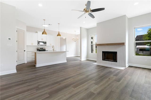35378 Liberty Dr, Slidell, LA 70460 - unfurnished living room featuring a sink, ceiling fan, dark wood-type flooring, a fireplace with flush hearth, and recessed lighting