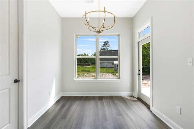 35378 Liberty Dr, Slidell, LA 70460 - unfurnished dining area with dark wood-type flooring, plenty of natural light, a chandelier, and baseboards