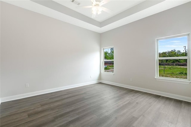 35378 Liberty Dr, Slidell, LA 70460 - spare room with dark wood-style flooring, a ceiling fan, baseboards, and a raised ceiling