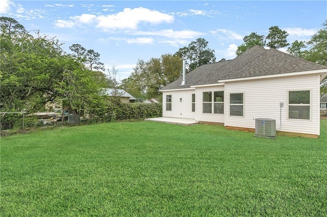35378 Liberty Dr, Slidell, LA 70460 - rear view of property featuring a shingled roof, a patio, a yard, and central air condition unit