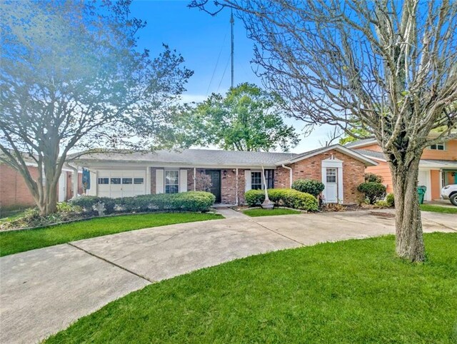632 Fairlawn Dr, Terrytown, LA 70056 - ranch-style home with brick siding, concrete driveway, a garage, and a front lawn