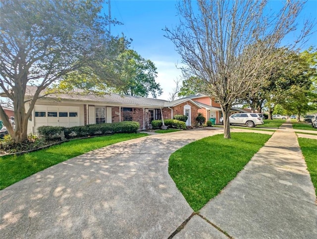 632 Fairlawn Dr, Terrytown, LA 70056 - view of front of house with brick siding, a garage, concrete driveway, and a front yard