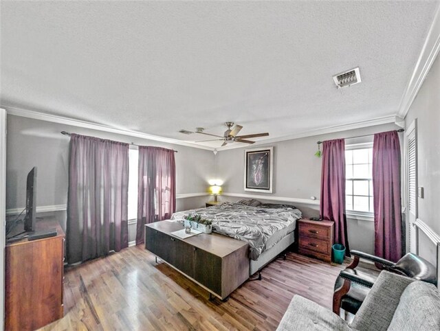 632 Fairlawn Dr, Terrytown, LA 70056 - bedroom featuring visible vents, ornamental molding, a textured ceiling, and wood finished floors