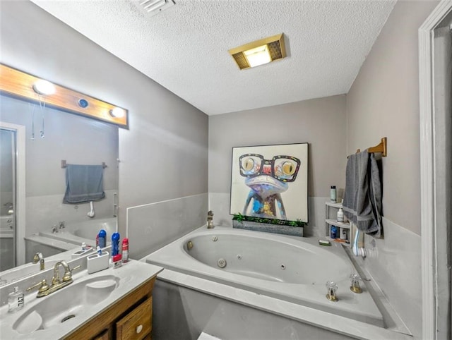 632 Fairlawn Dr, Terrytown, LA 70056 - bathroom featuring a tub with jets, vanity, visible vents, and a textured ceiling