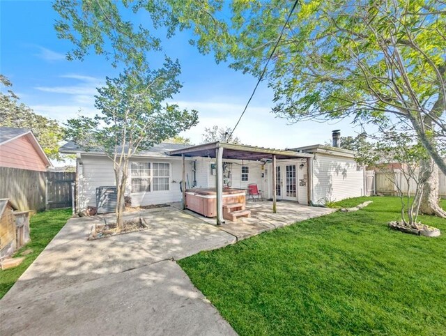 632 Fairlawn Dr, Terrytown, LA 70056 - rear view of house with a patio area, french doors, a hot tub, a fenced backyard, and a yard