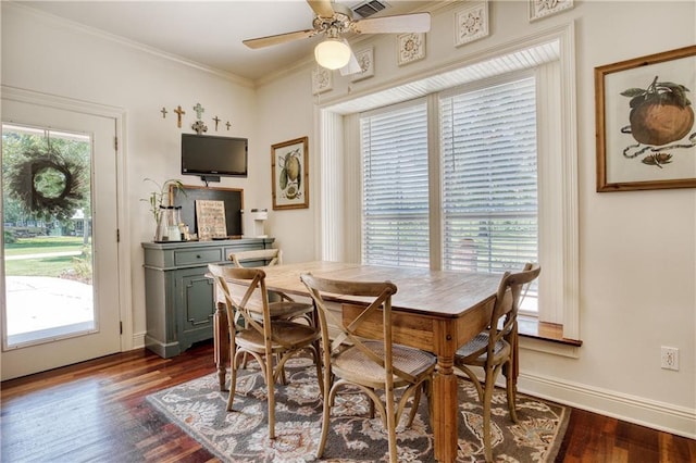 dining space with ornamental molding, baseboards, dark wood-style floors, visible vents, and ceiling fan