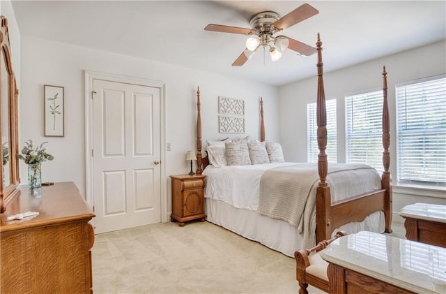 bedroom with light carpet and ceiling fan
