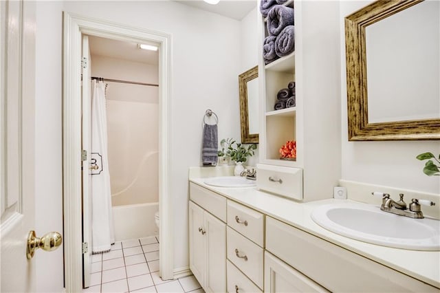 bathroom featuring double vanity, shower / bath combo with shower curtain, a sink, and tile patterned floors