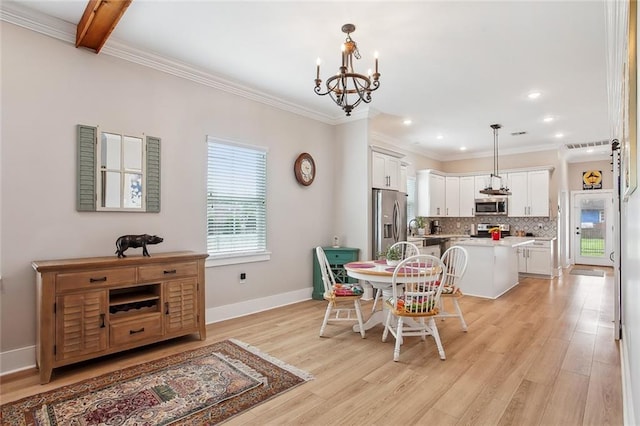 441 Hancock St, Gretna, LA 70053 - dining room featuring baseboards, a chandelier, light wood-style floors, and crown molding