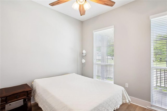 441 Hancock St, Gretna, LA 70053 - bedroom featuring a ceiling fan, baseboards, multiple windows, and wood finished floors