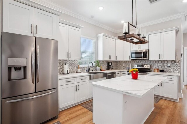 441 Hancock St, Gretna, LA 70053 - kitchen with ornamental molding, a sink, stainless steel appliances, and light wood finished floors