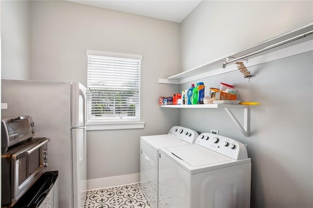 441 Hancock St, Gretna, LA 70053 - laundry room with independent washer and dryer, light tile patterned floors, baseboards, a toaster, and laundry area