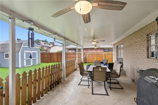 1100 Vintage Dr, Kenner, LA 70065 - view of patio / terrace with an outdoor structure, a fenced backyard, outdoor dining area, ceiling fan, and a storage shed