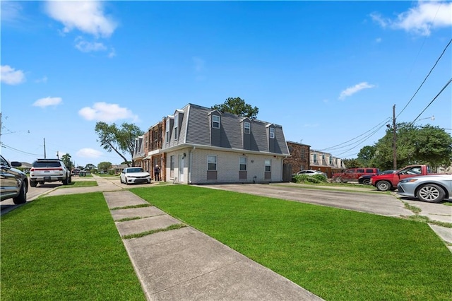 2900 Harvard Ave, Metairie, LA 70006 - view of side of property with a yard, uncovered parking, brick siding, and mansard roof