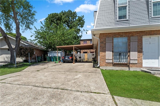 2900 Harvard Ave, Metairie, LA 70006 - view of side of home with driveway, brick siding, and an attached carport
