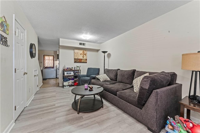 2900 Harvard Ave, Metairie, LA 70006 - living area with light wood finished floors and a textured ceiling