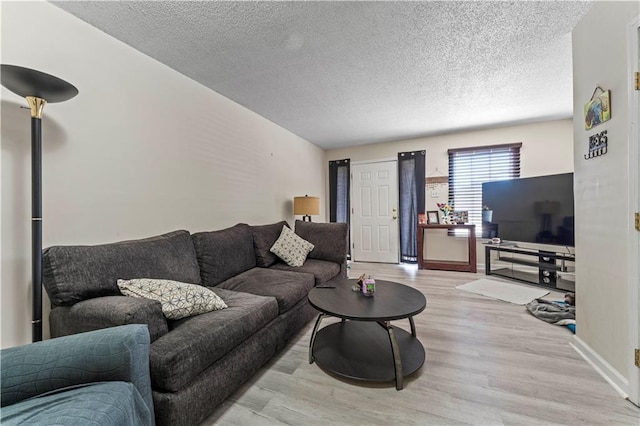 2900 Harvard Ave, Metairie, LA 70006 - living area with light wood-style flooring and a textured ceiling