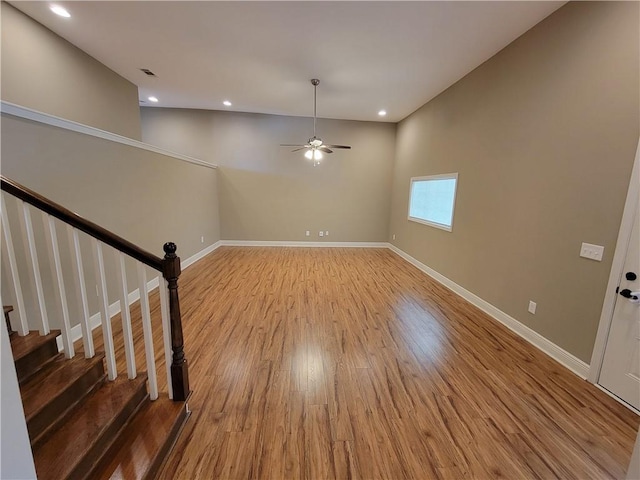 305 Amapola Cir, Terrytown, LA 70056 - spare room with wood finished floors, baseboards, ceiling fan, recessed lighting, and stairs