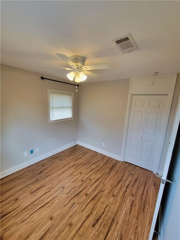 305 Amapola Cir, Terrytown, LA 70056 - unfurnished bedroom with wood finished floors, baseboards, and ceiling fan