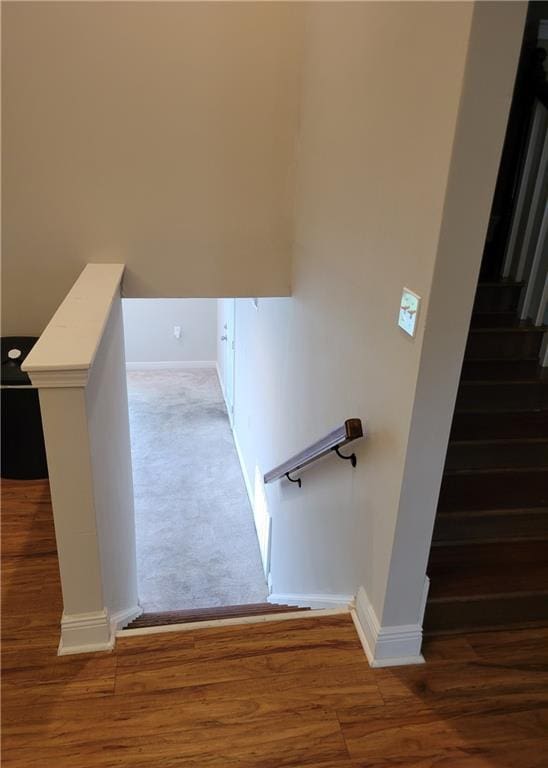 stairs featuring baseboards and wood finished floors