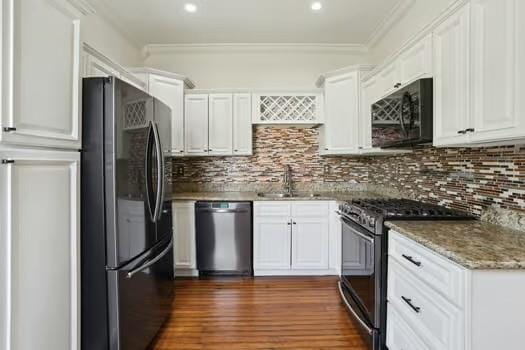 4674 Venus St, New Orleans, LA 70122 - kitchen featuring stainless steel appliances, white cabinetry, backsplash, crown molding, and dark wood-type flooring