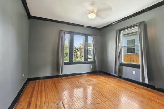 4674 Venus St, New Orleans, LA 70122 - unfurnished room with ornamental molding, hardwood / wood-style floors, and a ceiling fan