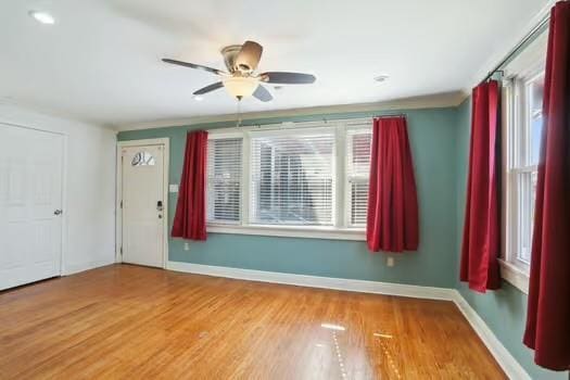 4674 Venus St, New Orleans, LA 70122 - unfurnished room with wood finished floors and ceiling fan