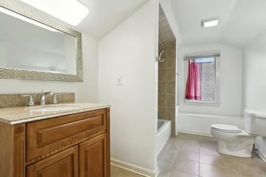 4674 Venus St, New Orleans, LA 70122 - full bathroom featuring vaulted ceiling, vanity, tile patterned flooring, and bathtub / shower combination