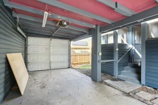 4674 Venus St, New Orleans, LA 70122 - garage featuring a garage door opener