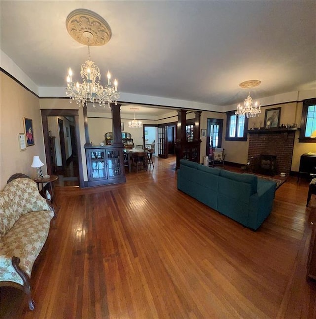 1508 Ellis Pkwy, Metairie, LA 70005 - living room with a brick fireplace, a notable chandelier, and wood finished floors