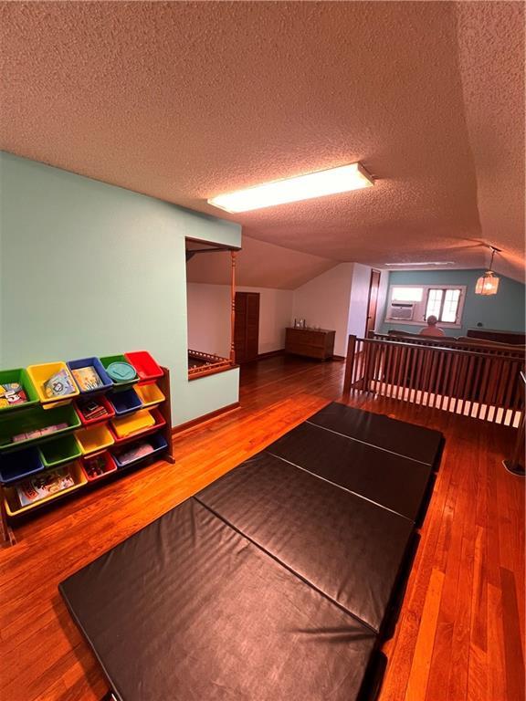 1508 Ellis Pkwy, Metairie, LA 70005 - interior space with a textured ceiling, wood finished floors, and lofted ceiling