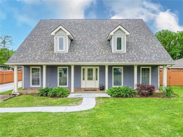 view of front of house with a front yard, fence, a shingled roof, and covered porch