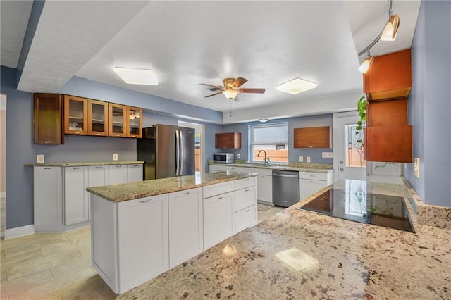 212 Somerset St, La Place, LA 70068 - kitchen featuring stainless steel appliances, glass insert cabinets, ceiling fan, white cabinets, and light stone counters