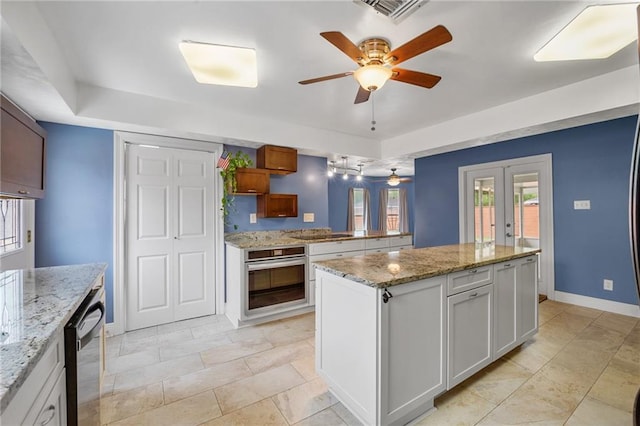 212 Somerset St, La Place, LA 70068 - kitchen featuring stainless steel oven, ceiling fan, dishwasher, baseboards, and a peninsula