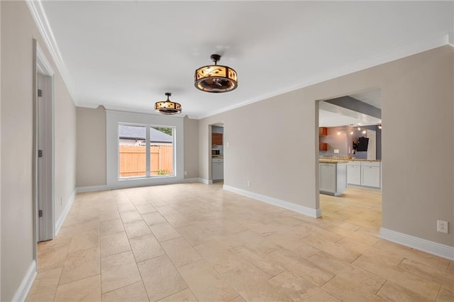 unfurnished living room with baseboards and ornamental molding