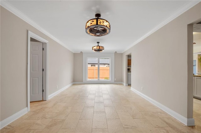 spare room with crown molding and baseboards
