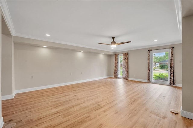 spare room featuring a ceiling fan, light wood finished floors, baseboards, and ornamental molding