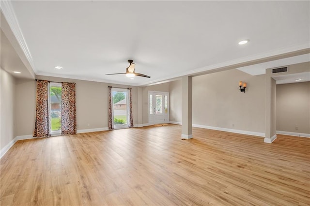 unfurnished living room featuring ceiling fan, baseboards, ornamental molding, and visible vents