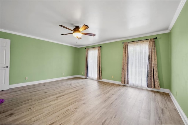 unfurnished room with ornamental molding, a healthy amount of sunlight, light wood finished floors, and a ceiling fan