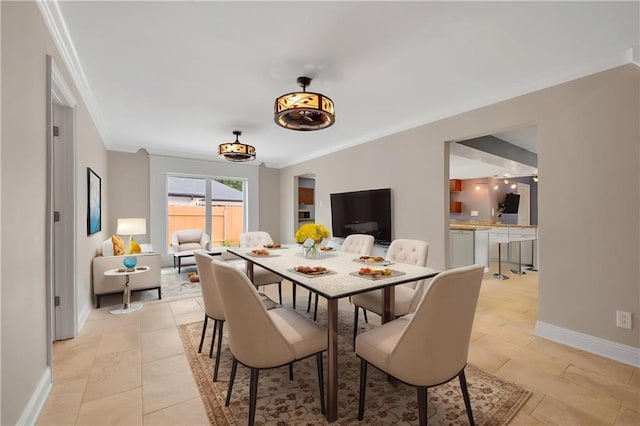 212 Somerset St, La Place, LA 70068 - dining room featuring crown molding, baseboards, and light tile patterned floors